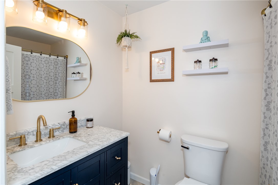 4102 Ridgetop Drive Bellbrook, OH 45305 - Photo 26 of 33 This bathroom features a contemporary vanity with a sleek countertop and elegant fixtures.