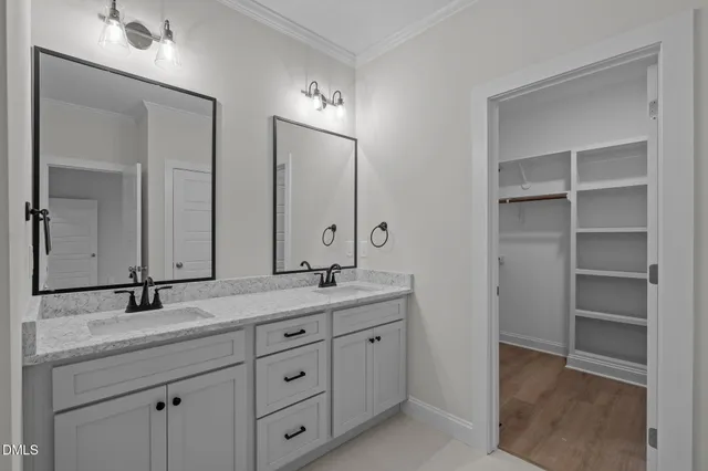 a bathroom with double sink and a mirror