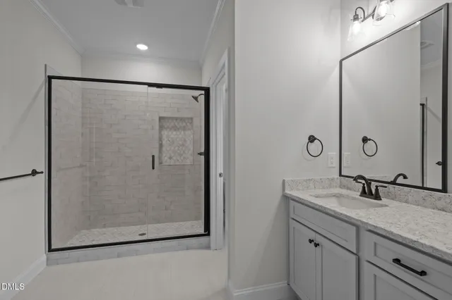 a bathroom with a shower sink and mirror