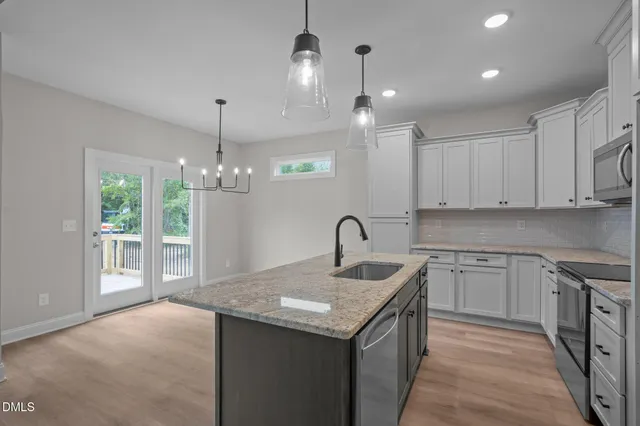 a kitchen with a sink stove and cabinets
