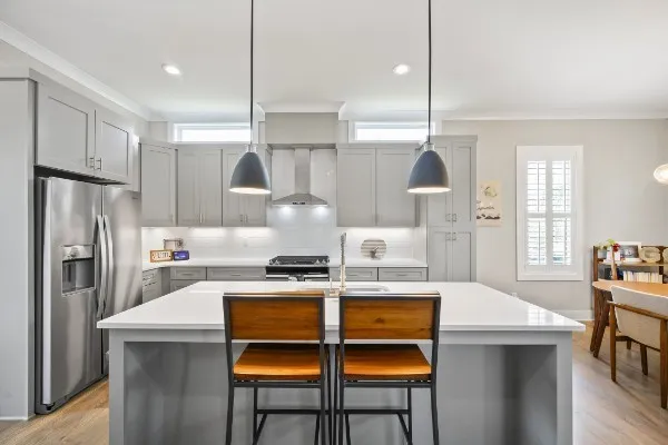 a kitchen with a stove a refrigerator a sink a dining table and chairs