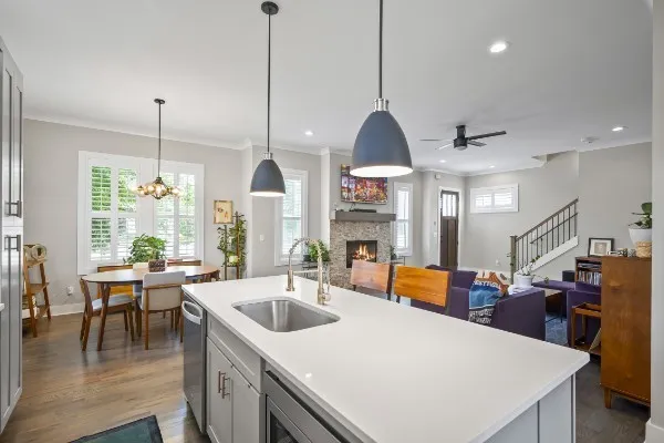 a kitchen with sink and view of living room