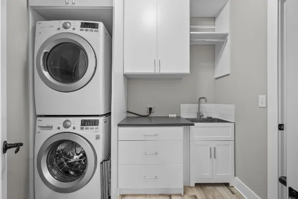 a utility room with sink dryer and washer