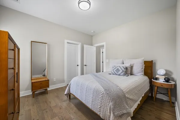 a bedroom with a bed and a chair