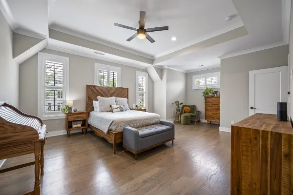 a spacious bedroom with a bed and a chandelier