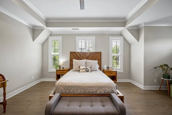 a bedroom with a bed and wooden floor