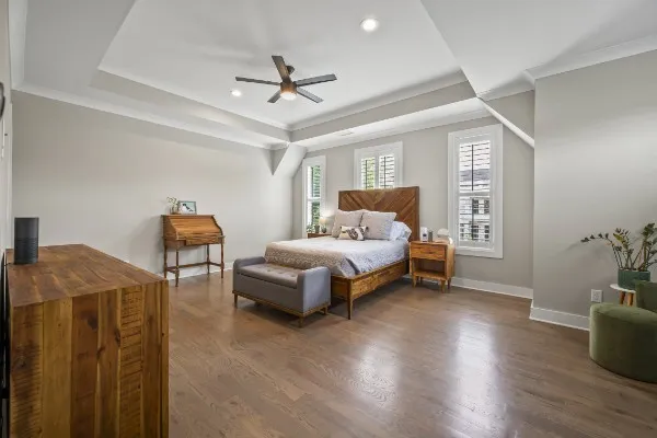 a bedroom with furniture and wooden floor