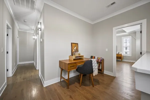 a view of a workspace with furniture and wooden floor