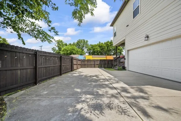 a view of backyard with wooden fence