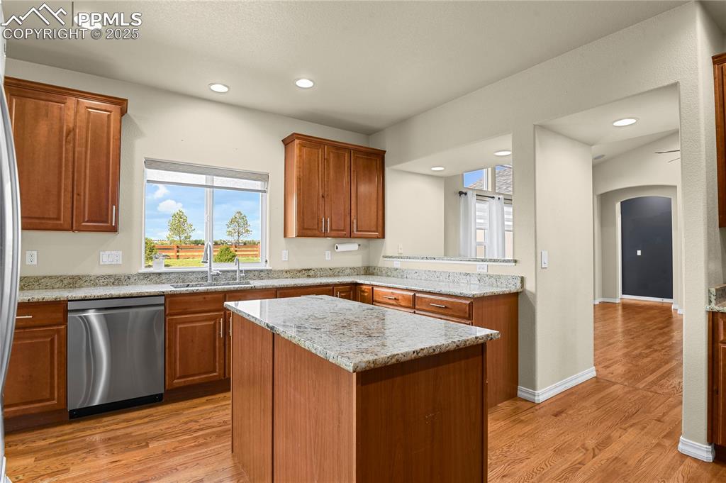 10530 Pictured Rocks Drive Peyton, CO 80831 - Photo 11 of 50 a kitchen with granite countertop kitchen island wooden cabinets granite counter tops and a window