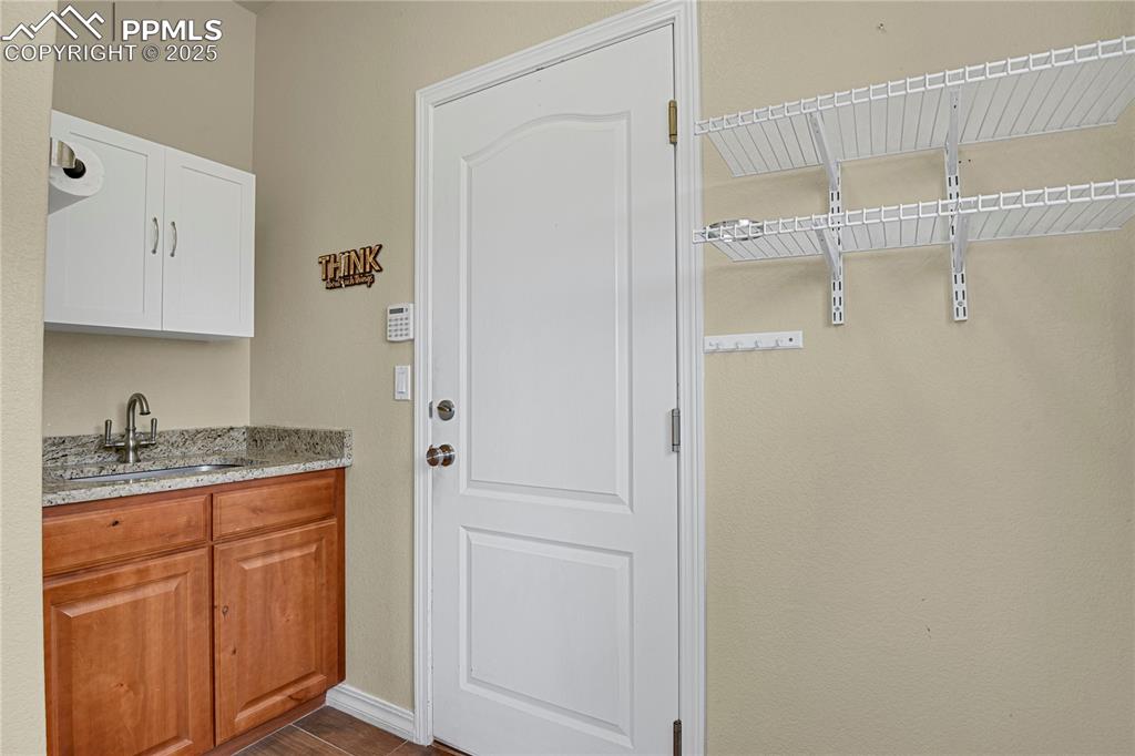 10530 Pictured Rocks Drive Peyton, CO 80831 - Photo 25 of 50 a bathroom with a granite countertop sink and a mirror