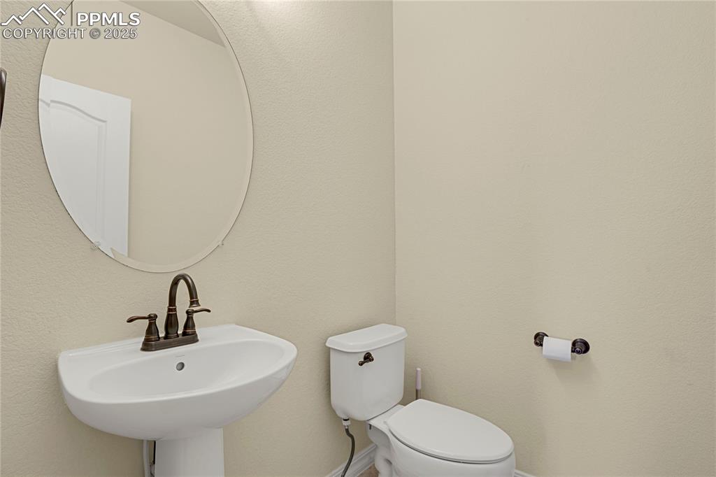 10530 Pictured Rocks Drive Peyton, CO 80831 - Photo 26 of 50 a bathroom with a sink a mirror and toilet