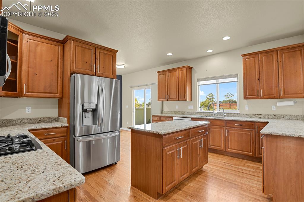 10530 Pictured Rocks Drive Peyton, CO 80831 - Photo 10 of 50 a kitchen with wooden cabinets sink and stainless steel appliances