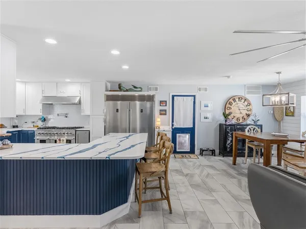 a kitchen with stainless steel appliances granite countertop a stove and a refrigerator