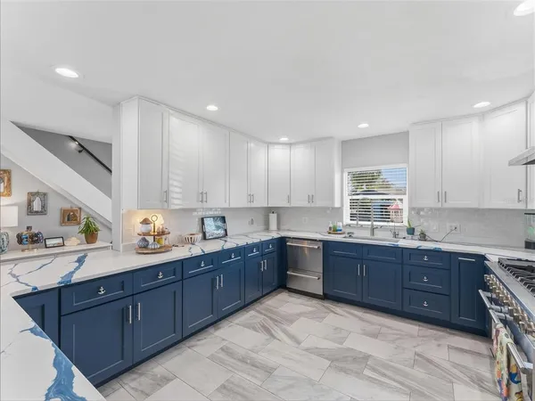 a kitchen with a sink stove and cabinets