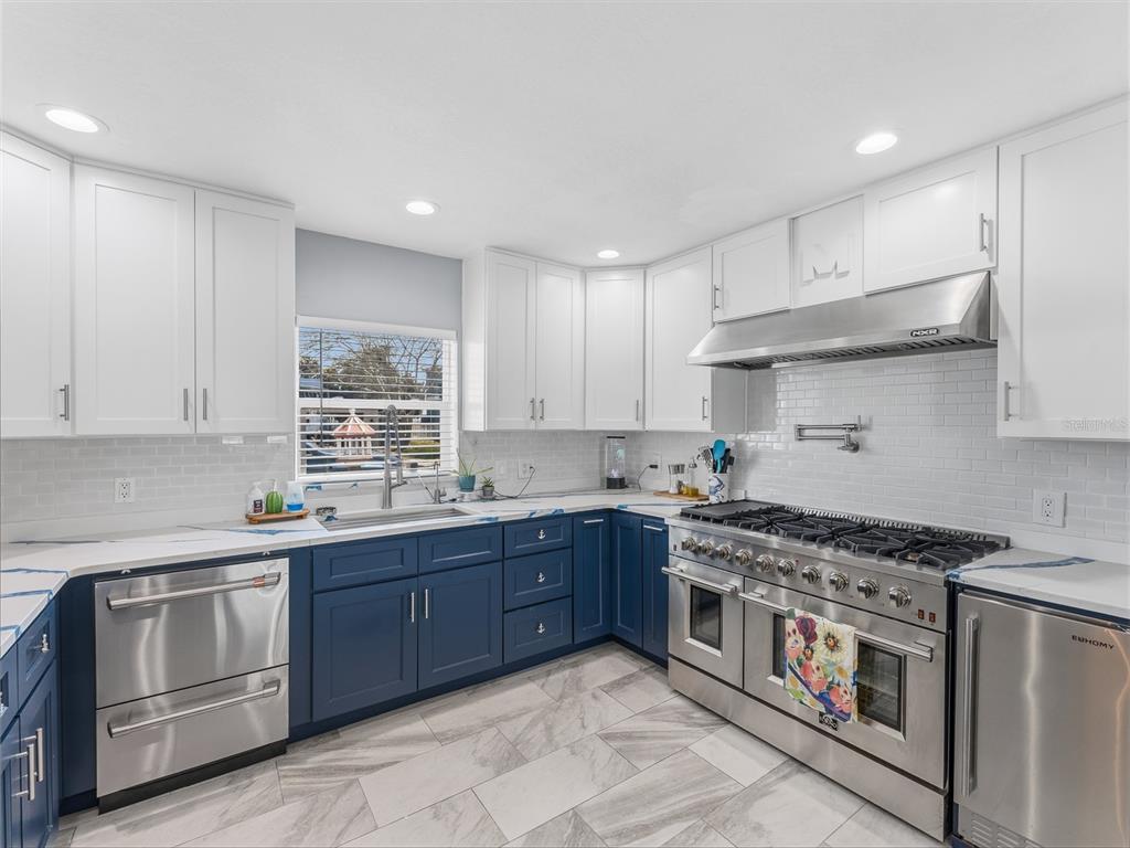 3173 Gulfview Drive Hernando Beach, FL 34607 - Photo 19 of 75 a kitchen with stainless steel appliances granite countertop a stove a sink dishwasher and a refrigerator