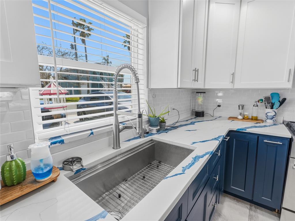3173 Gulfview Drive Hernando Beach, FL 34607 - Photo 23 of 75 a kitchen with a sink stove and cabinets
