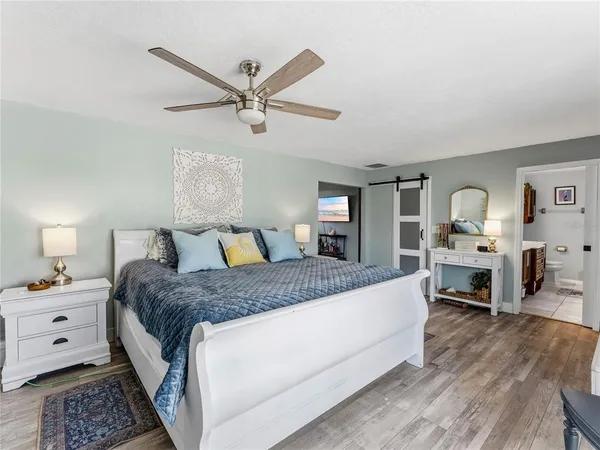 a bedroom with a bed and a chandelier