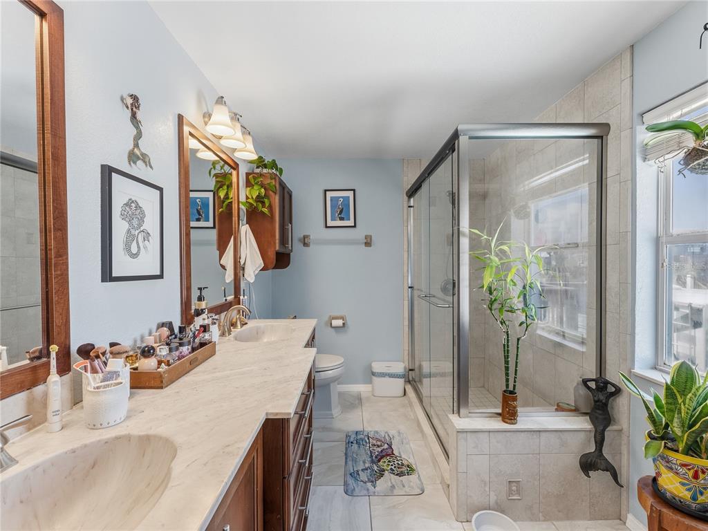 3173 Gulfview Drive Hernando Beach, FL 34607 - Photo 26 of 75 a en suite bathroom with a granite countertop sink and a mirror