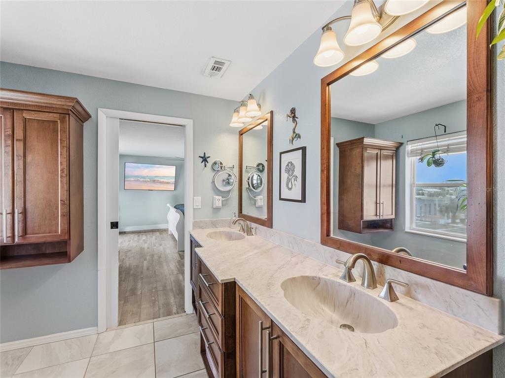 3173 Gulfview Drive Hernando Beach, FL 34607 - Photo 27 of 75 a bathroom with a granite countertop sink and a mirror