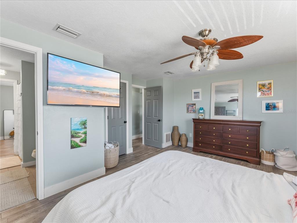 3173 Gulfview Drive Hernando Beach, FL 34607 - Photo 32 of 75 a bedroom with a bed and a chandelier