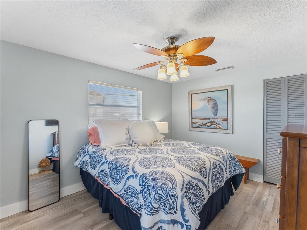 3173 Gulfview Drive Hernando Beach, FL 34607 - Photo 35 of 75 a bedroom with a bed and a chandelier