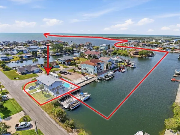 an aerial view of a house with a ocean view