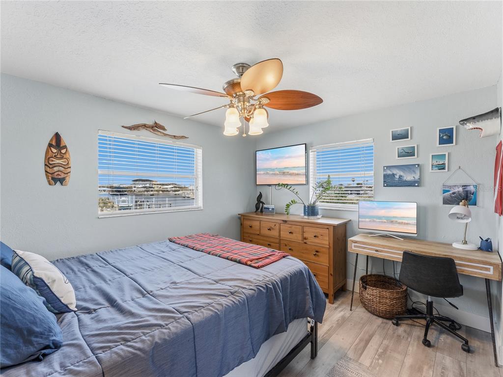 3173 Gulfview Drive Hernando Beach, FL 34607 - Photo 41 of 75 a bedroom with a bed and a chandelier