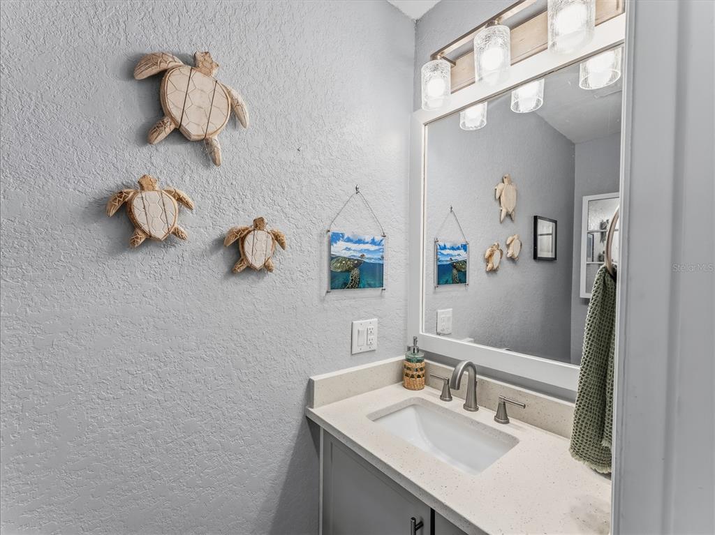 3173 Gulfview Drive Hernando Beach, FL 34607 - Photo 48 of 75 a bathroom with a sink vanity and mirror