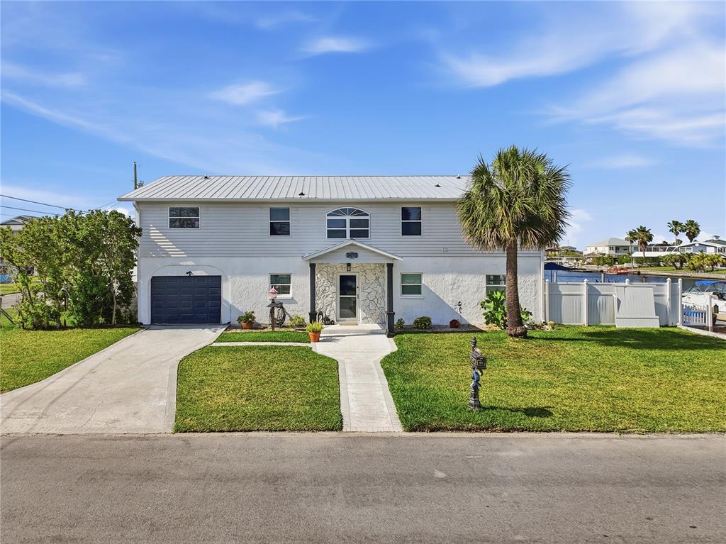 3173 Gulfview Drive Hernando Beach, FL 34607 - Photo 9 of 75 a front view of a house with garden