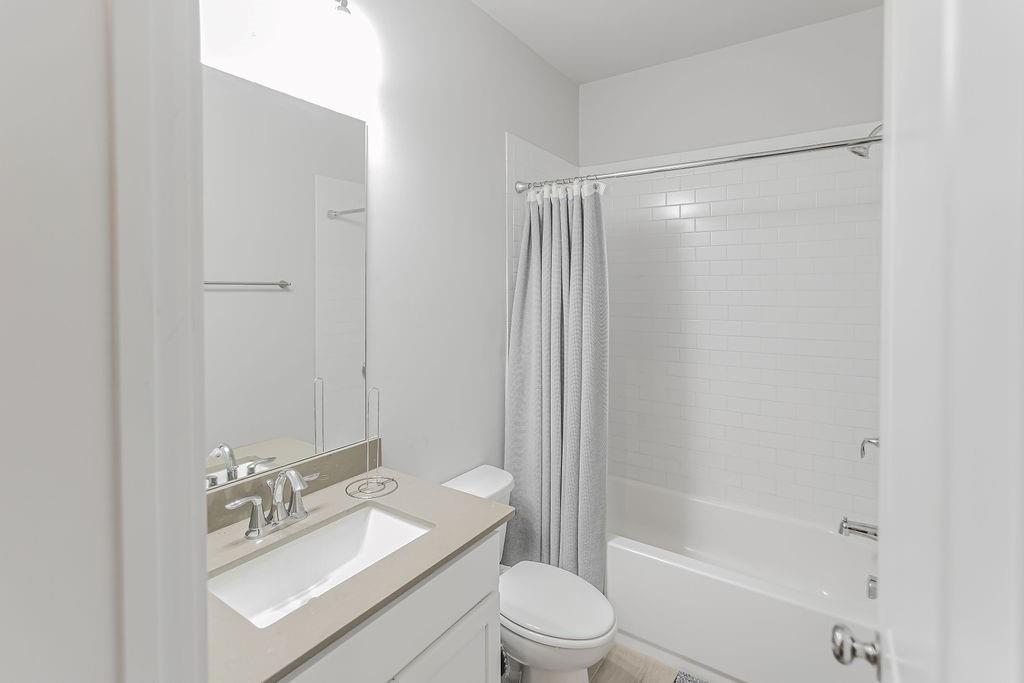 2170 Wiggins Walk Atlanta, GA 30316 - Photo 10 of 17 a bathroom with a granite countertop sink toilet and shower