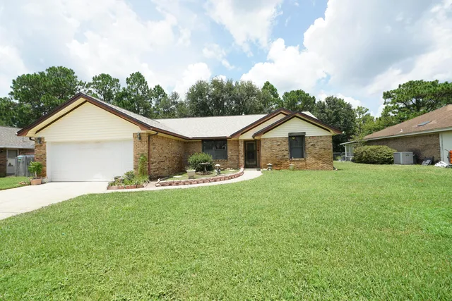 a front view of house with yard and green space