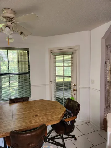 a room with pool table and windows