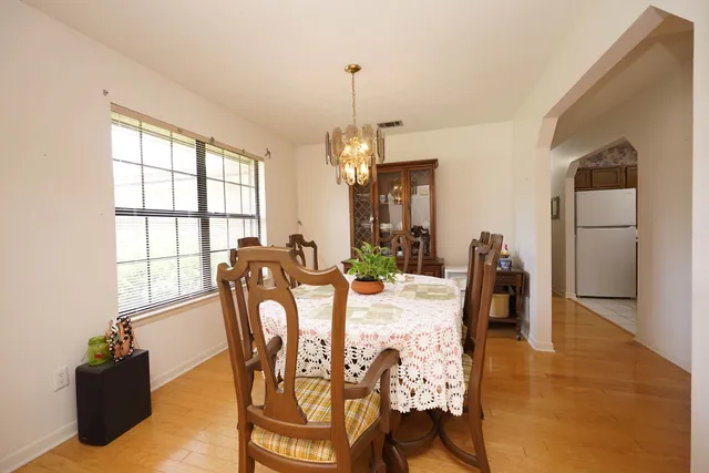 a view of a dining room with furniture and a chandelier