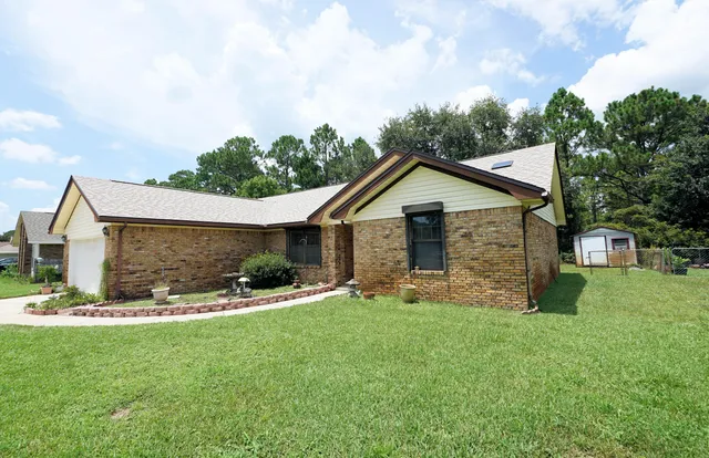 a front view of house with yard and green space