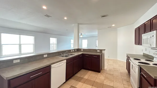 a kitchen with a sink stove and cabinets