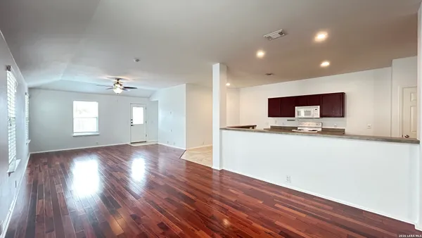 a view of kitchen with sink and wooden floor
