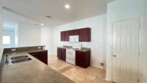 a kitchen with stainless steel appliances granite countertop a stove and a refrigerator