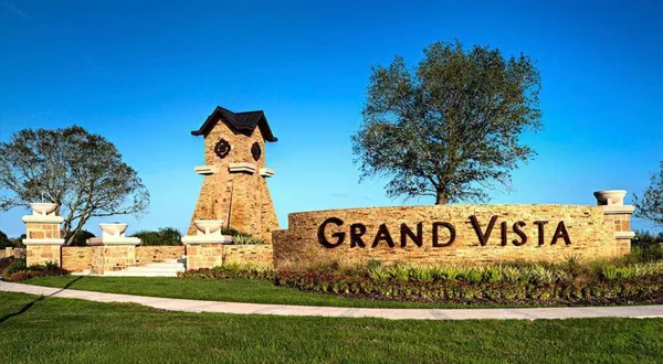 a sign of golf club on a wall under a tree