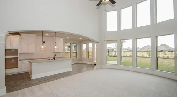 a large white kitchen with a large window