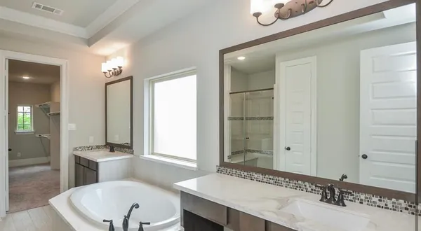 a bathroom with a double vanity sink and a mirror