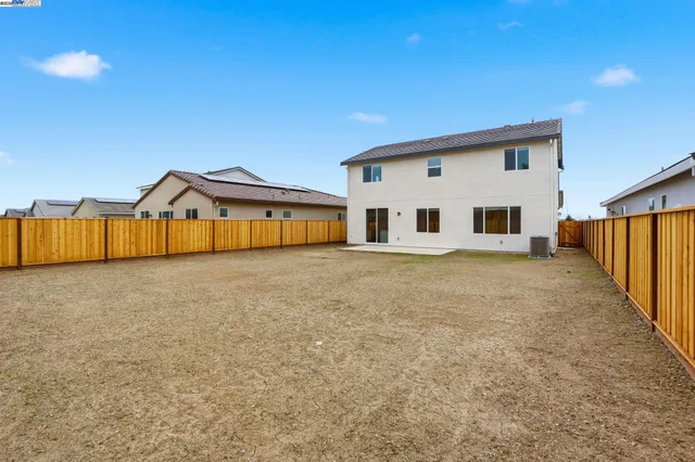 a view of a house with wooden fence