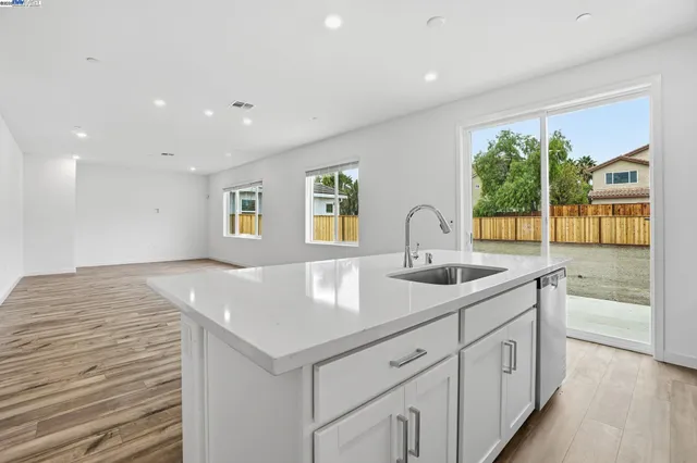 a kitchen with a sink and large window