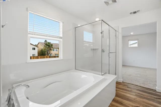 a bathroom with a bathtub and a shower