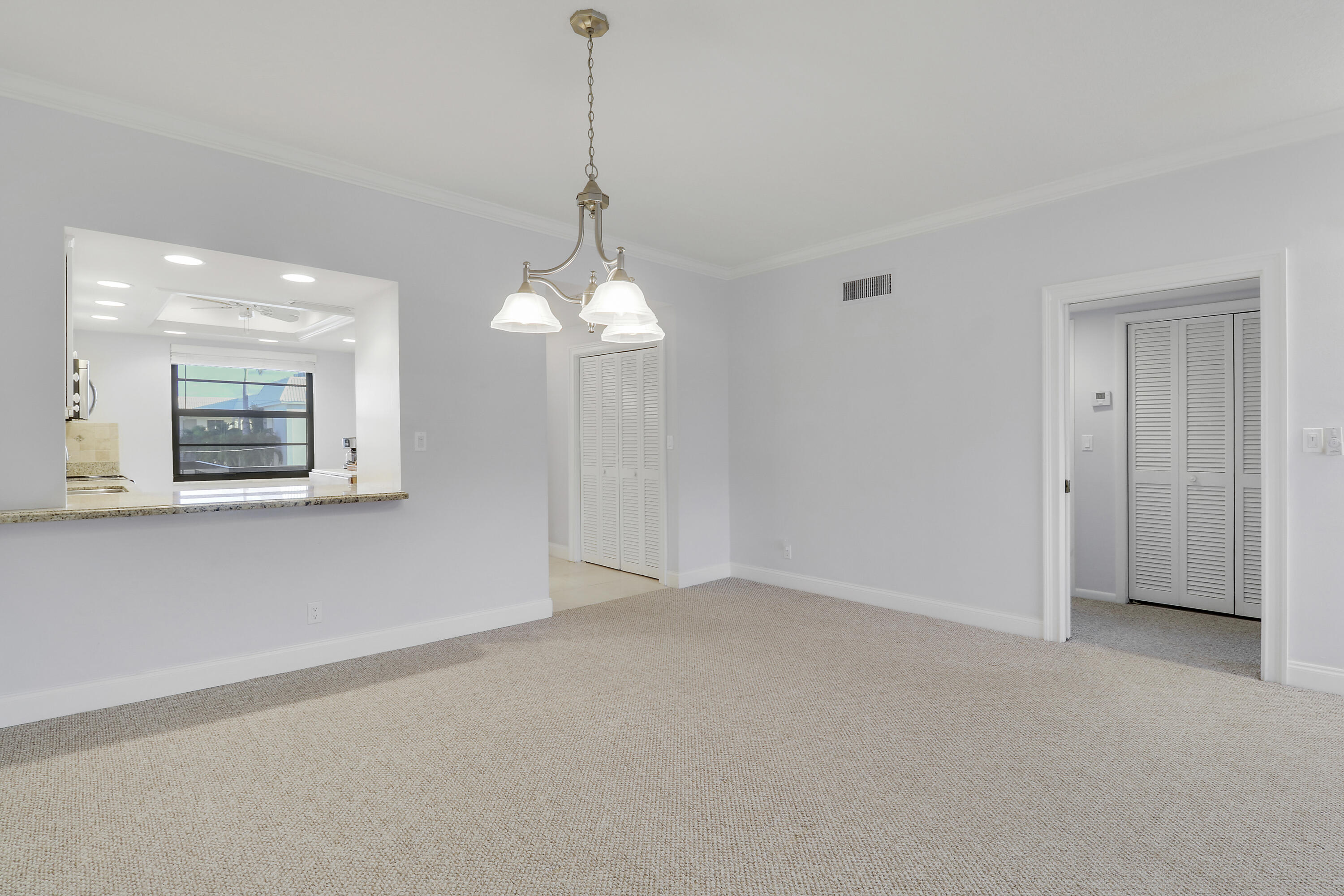 275 South Beach Road, Unit B202 Tequesta, FL 33469 - Photo 15 of 37 a view of a room with a chandelier fan and windows