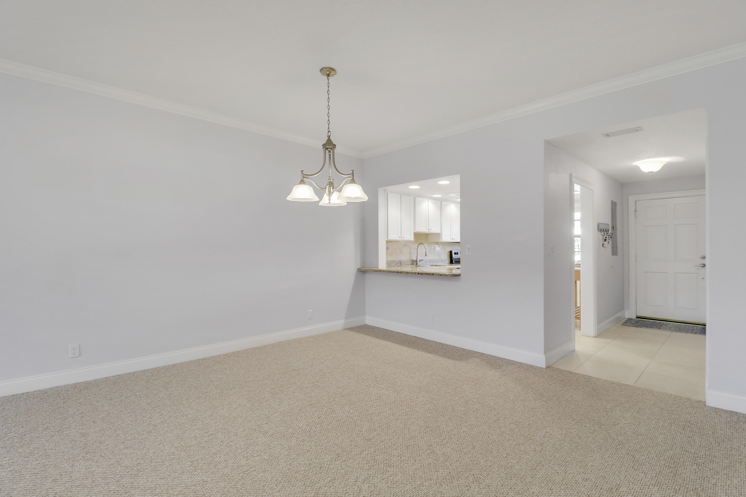 275 South Beach Road, Unit B202 Tequesta, FL 33469 - Photo 16 of 37 a view of a room with a chandelier fan and windows