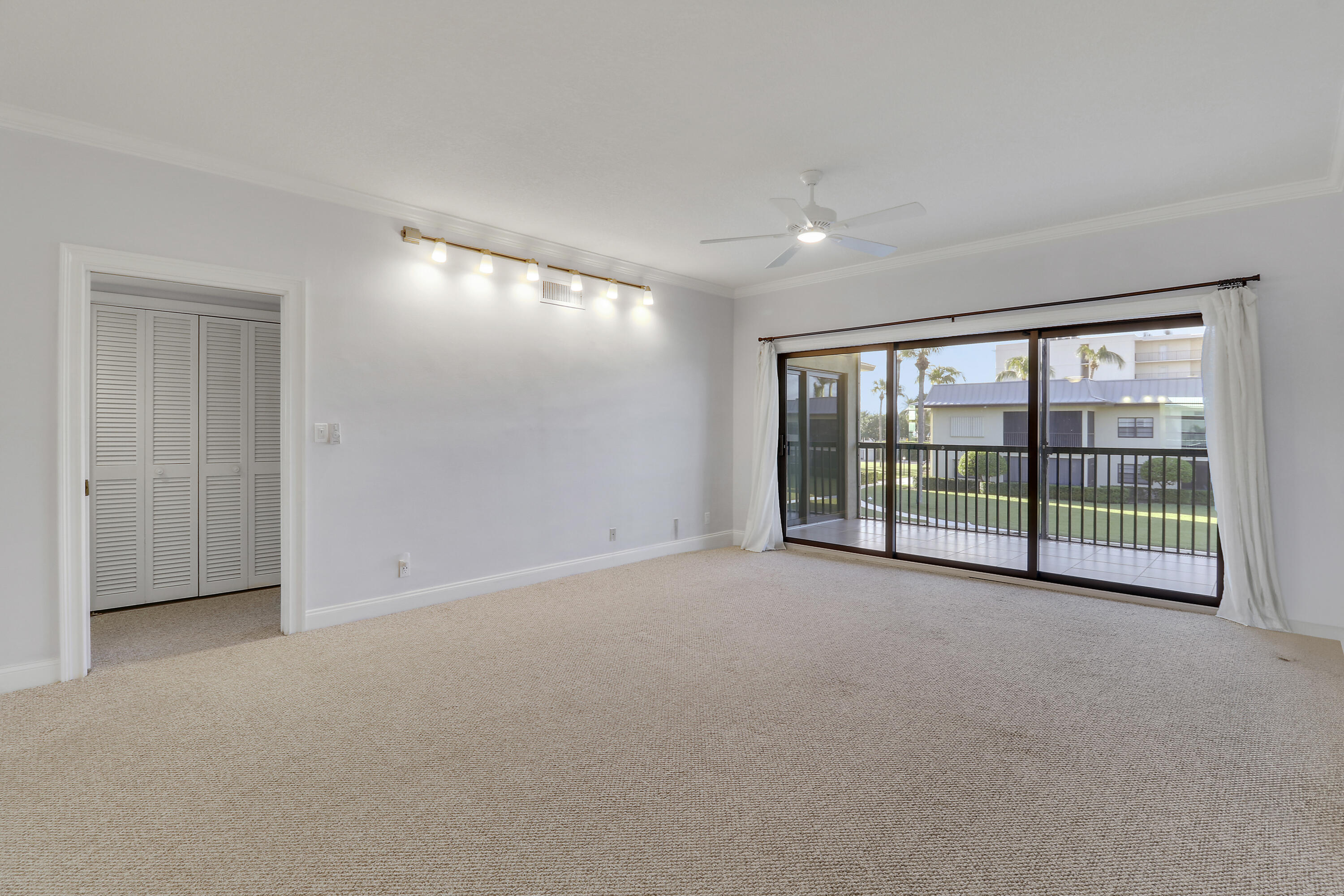 275 South Beach Road, Unit B202 Tequesta, FL 33469 - Photo 19 of 37 a view of an empty room with a sliding door