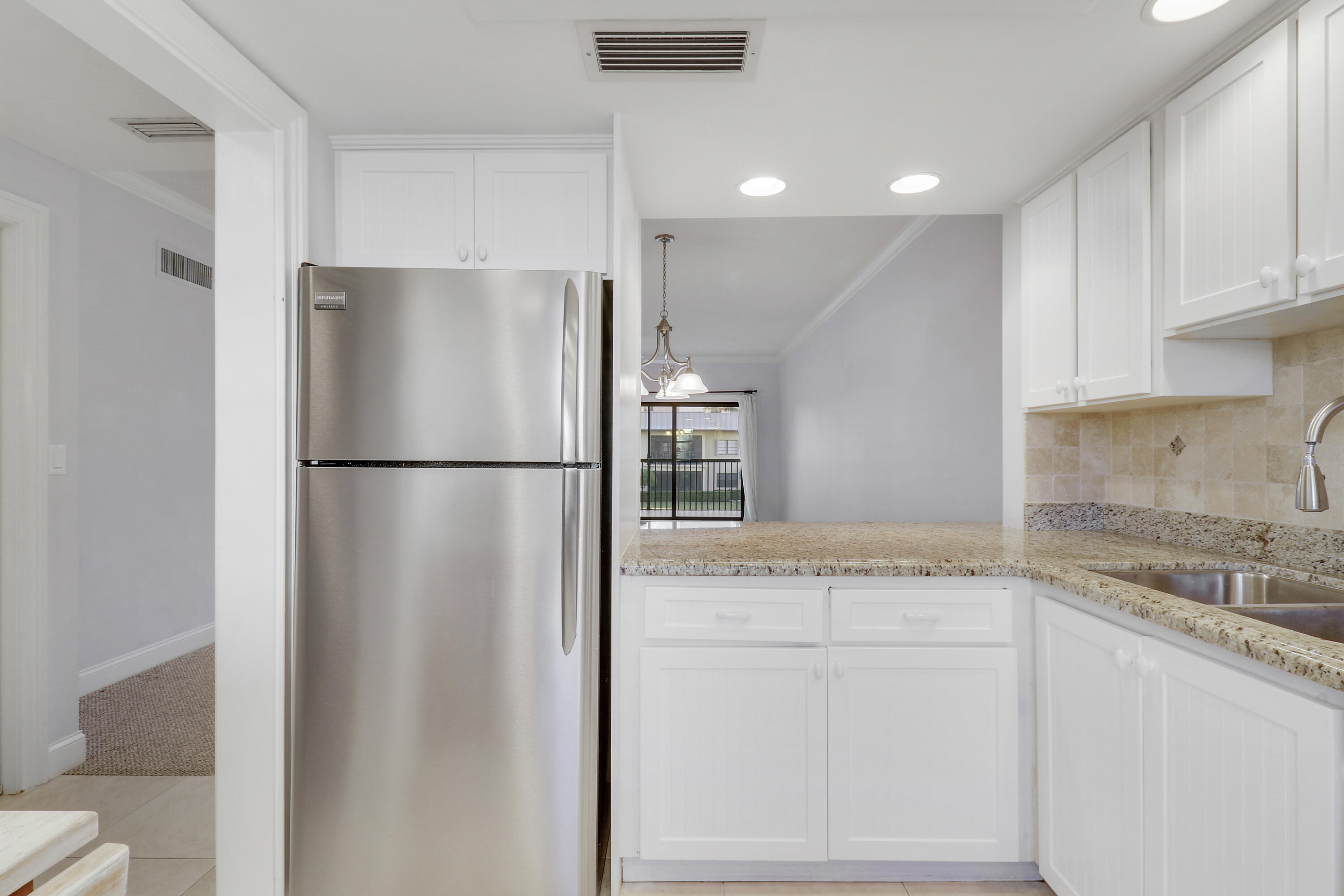 275 South Beach Road, Unit B202 Tequesta, FL 33469 - Photo 24 of 37 a kitchen with appliances cabinets and a counter top space