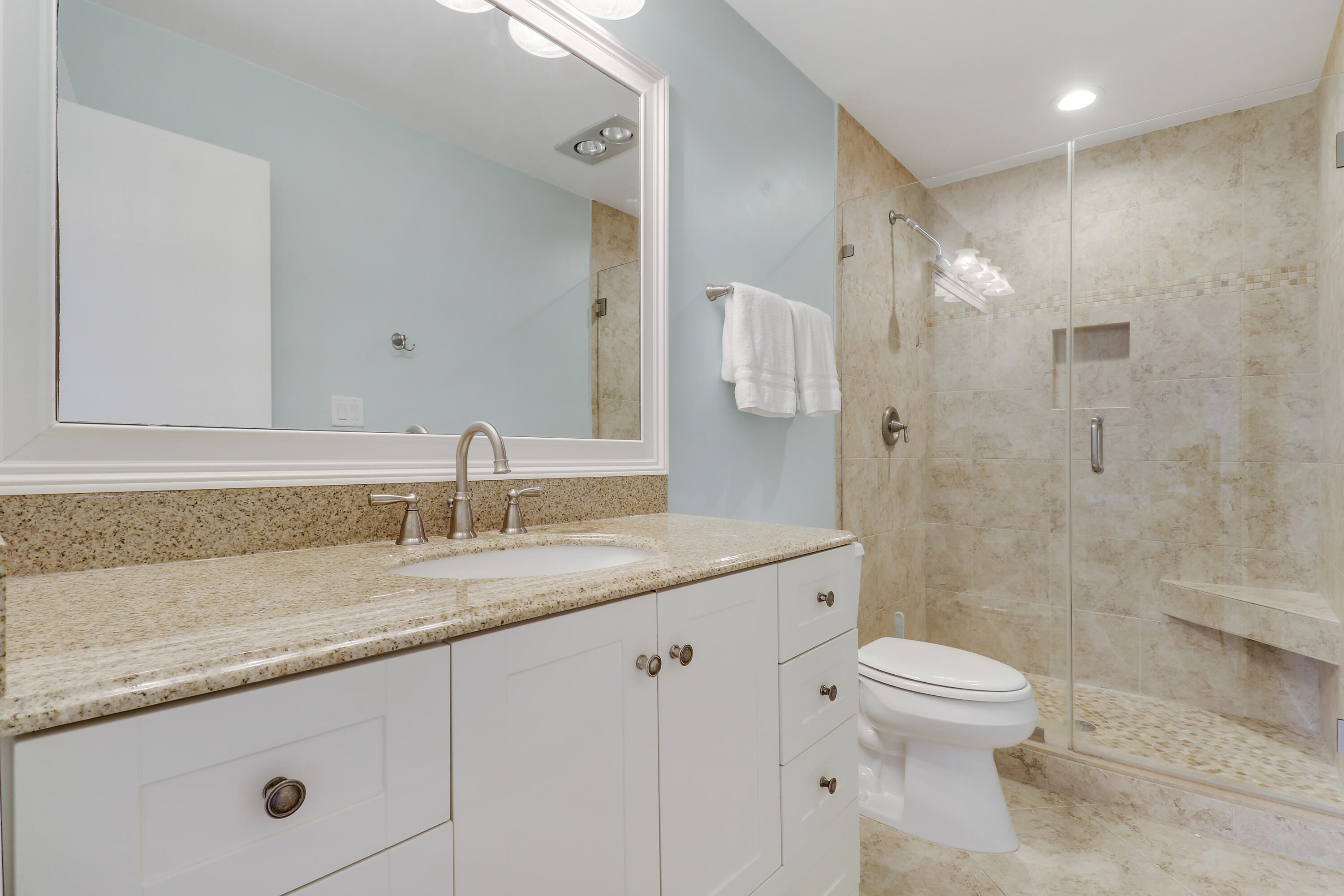 275 South Beach Road, Unit B202 Tequesta, FL 33469 - Photo 35 of 37 a bathroom with a granite countertop sink a toilet and a shower