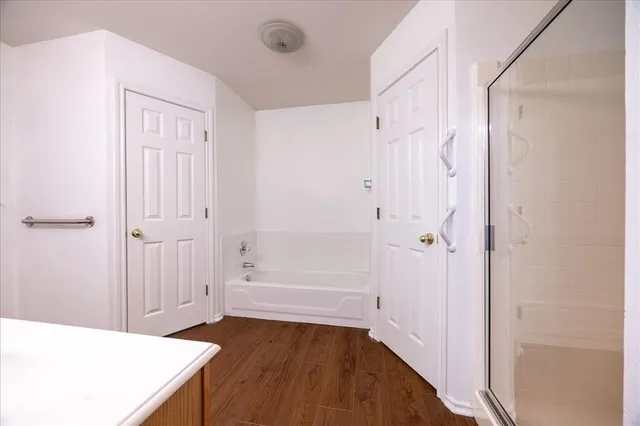 a view of an empty room with wooden floor